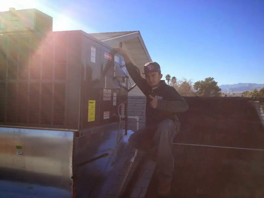 HVAC technician performing HVAC Inspection on a rooftop unit in Pryor Creek